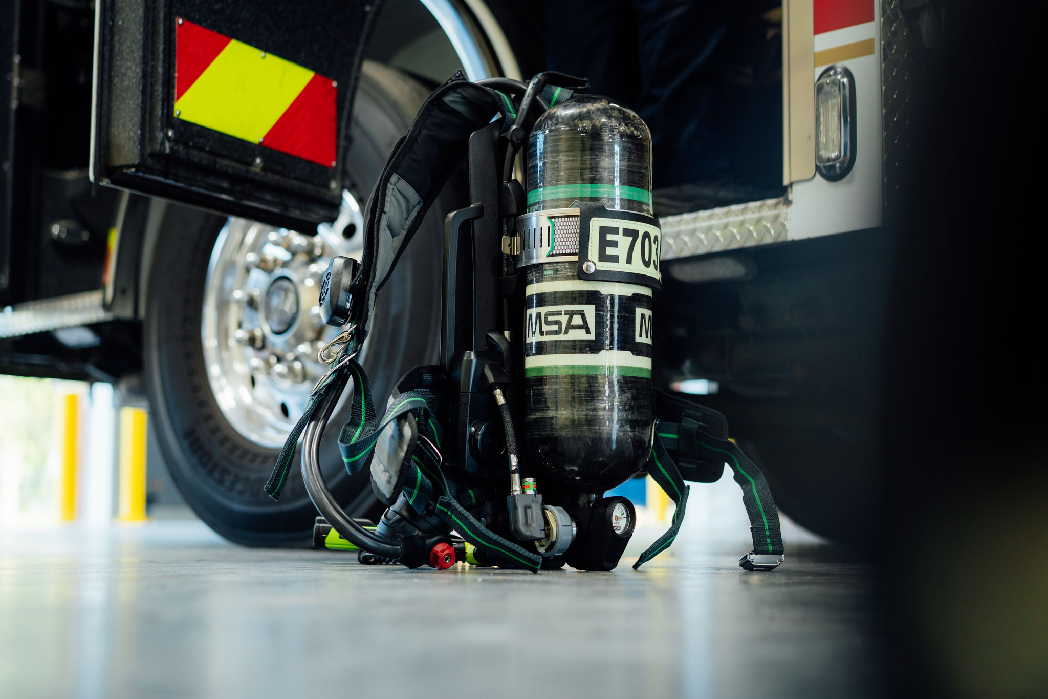 An MSA air pack staged on the bay floor beside an engine
